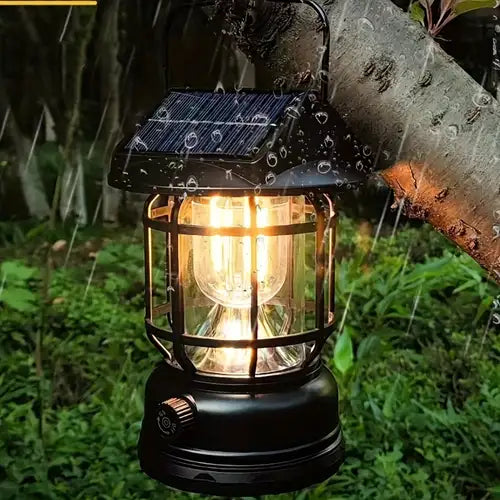 Solar-powered outdoor lantern with a warm glow, attached to a tree branch in a natural setting.
